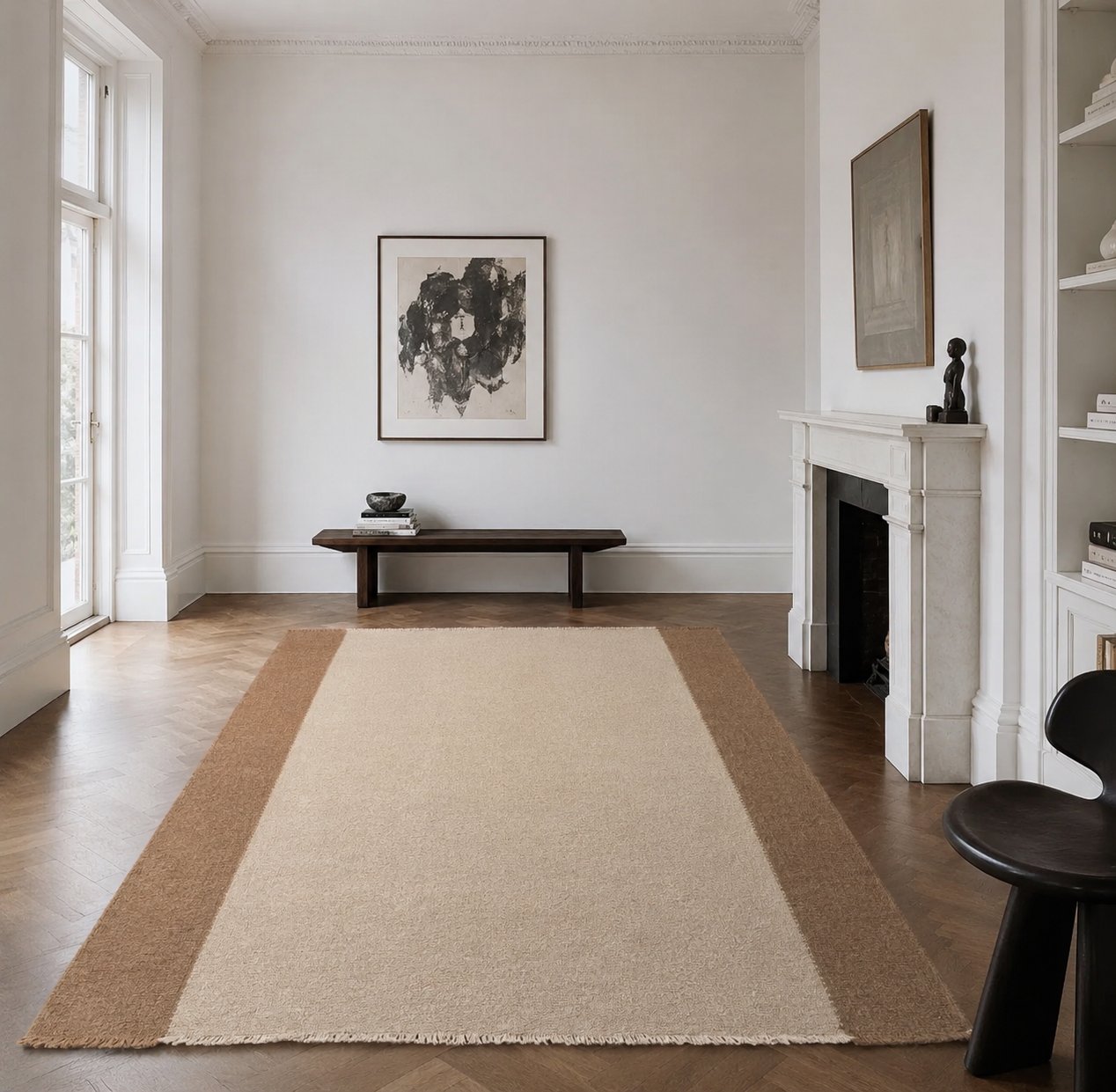 Cream rug with wide brown border in living room